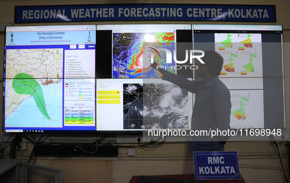 A scientist at the India Meteorological Department Earth System Science Organisation points to a section of the screen showing the position...