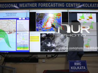 A scientist at the India Meteorological Department Earth System Science Organisation points to a section of the screen showing the position...