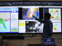 A scientist at the India Meteorological Department Earth System Science Organisation points to a section of the screen showing the position...