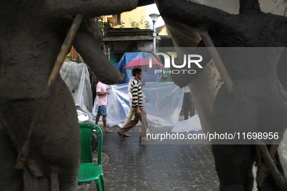 A man with an umbrella walks on a road during rains caused by Cyclone Dana in Kolkata, India, on October 23, 2024. The Regional Meteorologic...