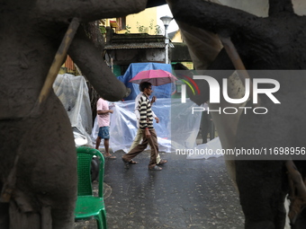 A man with an umbrella walks on a road during rains caused by Cyclone Dana in Kolkata, India, on October 23, 2024. The Regional Meteorologic...