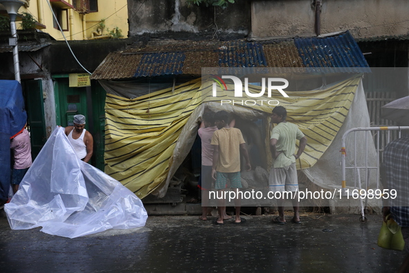 Workers cover idols of the Hindu goddess Kali with a plastic sheet ahead of Cyclone Dana in Kolkata, India, on October 23, 2024. The Regiona...