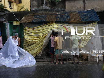 Workers cover idols of the Hindu goddess Kali with a plastic sheet ahead of Cyclone Dana in Kolkata, India, on October 23, 2024. The Regiona...