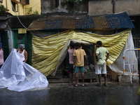 Workers cover idols of the Hindu goddess Kali with a plastic sheet ahead of Cyclone Dana in Kolkata, India, on October 23, 2024. The Regiona...