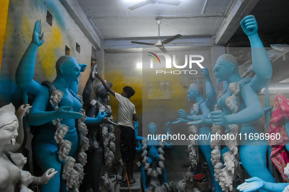 Artists give final touches to idols of Goddess Kali ahead of the Kali Puja festival in Kolkata, India, on October 23, 2024. 