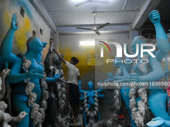 Artists give final touches to idols of Goddess Kali ahead of the Kali Puja festival in Kolkata, India, on October 23, 2024. (