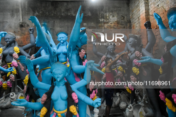 Artists give final touches to idols of Goddess Kali ahead of the Kali Puja festival in Kolkata, India, on October 23, 2024. 