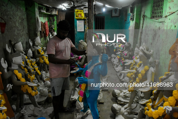 Artists give final touches to idols of Goddess Kali ahead of the Kali Puja festival in Kolkata, India, on October 23, 2024. 