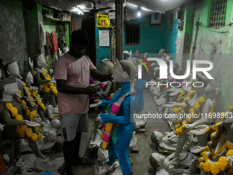 Artists give final touches to idols of Goddess Kali ahead of the Kali Puja festival in Kolkata, India, on October 23, 2024. (