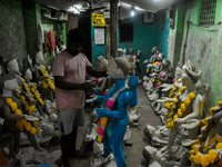 Artists give final touches to idols of Goddess Kali ahead of the Kali Puja festival in Kolkata, India, on October 23, 2024. (