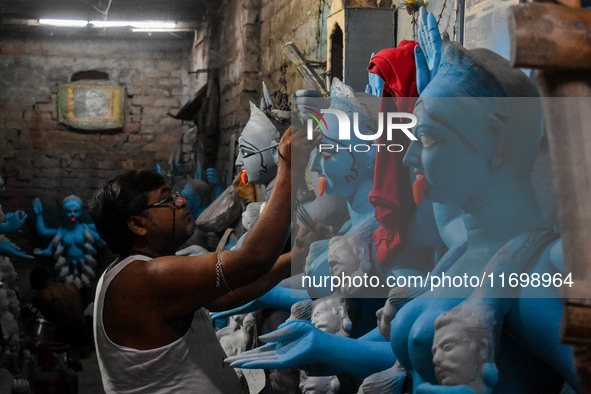 Artists give final touches to idols of Goddess Kali ahead of the Kali Puja festival in Kolkata, India, on October 23, 2024. 