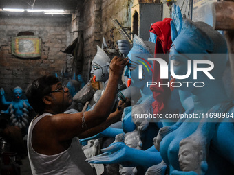 Artists give final touches to idols of Goddess Kali ahead of the Kali Puja festival in Kolkata, India, on October 23, 2024. (