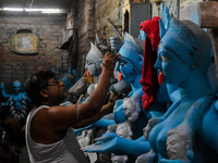 Artists give final touches to idols of Goddess Kali ahead of the Kali Puja festival in Kolkata, India, on October 23, 2024. (