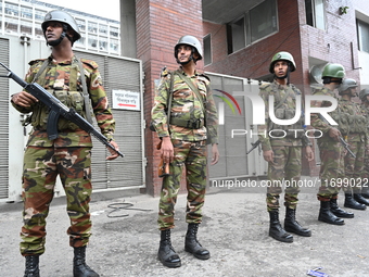 Bangladesh army soldiers stand guard in front of the Secretariat as HSC (Higher Secondary Certificate) students, who fail or receive poor re...