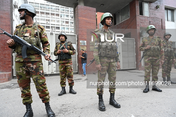 Bangladesh army soldiers stand guard in front of the Secretariat as HSC (Higher Secondary Certificate) students, who fail or receive poor re...