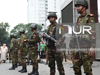 Bangladesh army soldiers stand guard in front of the Secretariat as HSC (Higher Secondary Certificate) students, who fail or receive poor re...