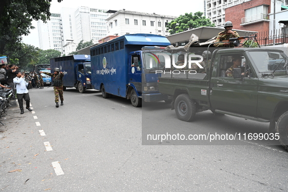 Prison vans transport students after police detain over 50 students for questioning from the Secretariat in Dhaka, Bangladesh, on October 23...