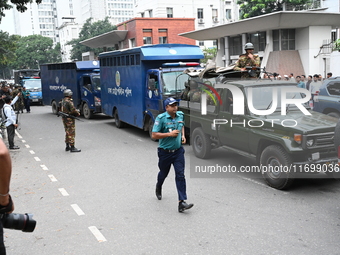 Prison vans transport students after police detain over 50 students for questioning from the Secretariat in Dhaka, Bangladesh, on October 23...