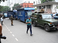 Prison vans transport students after police detain over 50 students for questioning from the Secretariat in Dhaka, Bangladesh, on October 23...