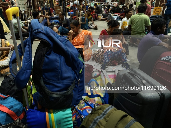 Passengers rest and wait at Howrah train station in Howrah, West Bengal, India, on October 23, 2024. East Coast Railways cancels as many as...