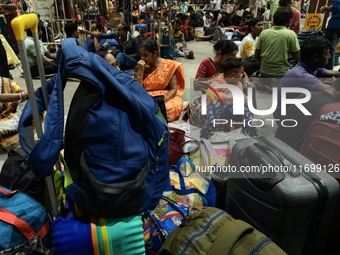 Passengers rest and wait at Howrah train station in Howrah, West Bengal, India, on October 23, 2024. East Coast Railways cancels as many as...