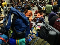 Passengers rest and wait at Howrah train station in Howrah, West Bengal, India, on October 23, 2024. East Coast Railways cancels as many as...