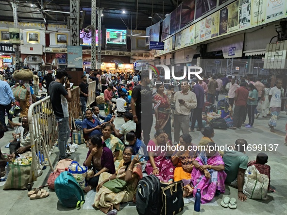 Passengers rest and wait at Howrah train station in Howrah, West Bengal, India, on October 23, 2024. East Coast Railways cancels as many as...