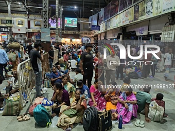 Passengers rest and wait at Howrah train station in Howrah, West Bengal, India, on October 23, 2024. East Coast Railways cancels as many as...