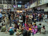 Passengers rest and wait at Howrah train station in Howrah, West Bengal, India, on October 23, 2024. East Coast Railways cancels as many as...