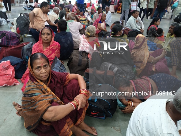 Passengers rest and wait at Howrah train station in Howrah, West Bengal, India, on October 23, 2024. East Coast Railways cancels as many as...