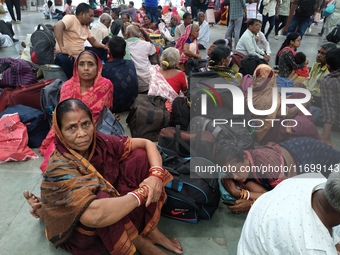 Passengers rest and wait at Howrah train station in Howrah, West Bengal, India, on October 23, 2024. East Coast Railways cancels as many as...