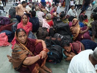 Passengers rest and wait at Howrah train station in Howrah, West Bengal, India, on October 23, 2024. East Coast Railways cancels as many as...