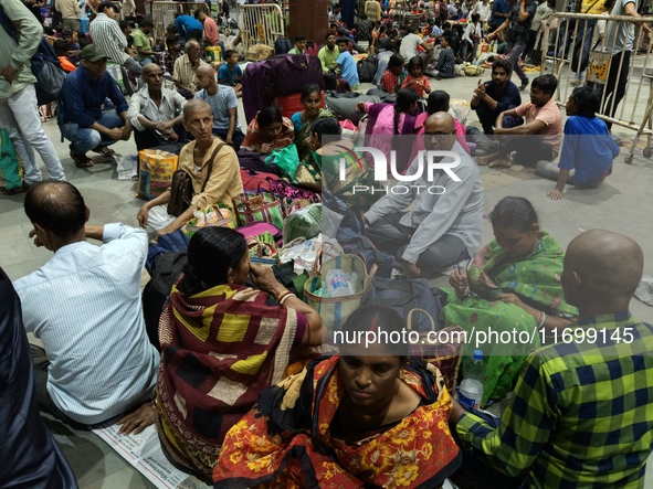 Passengers rest and wait at Howrah train station in Howrah, West Bengal, India, on October 23, 2024. East Coast Railways cancels as many as...