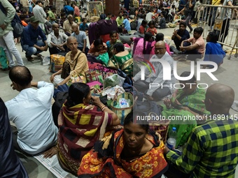 Passengers rest and wait at Howrah train station in Howrah, West Bengal, India, on October 23, 2024. East Coast Railways cancels as many as...