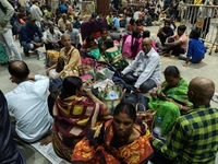 Passengers rest and wait at Howrah train station in Howrah, West Bengal, India, on October 23, 2024. East Coast Railways cancels as many as...