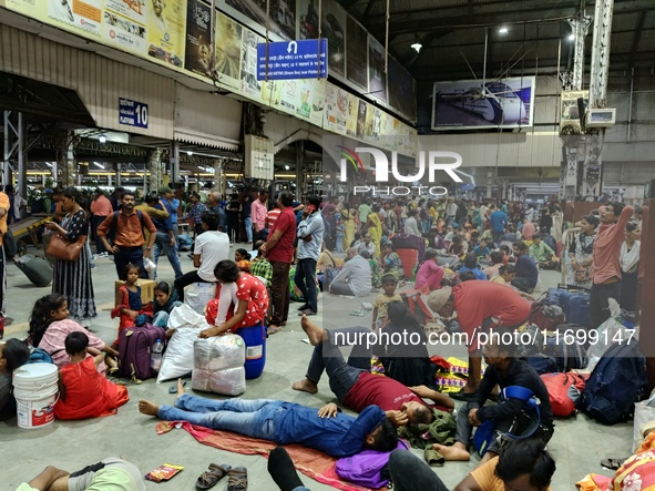 Passengers rest and wait at Howrah train station in Howrah, West Bengal, India, on October 23, 2024. East Coast Railways cancels as many as...