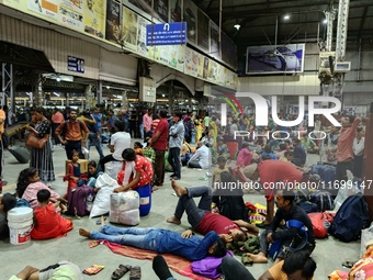 Passengers rest and wait at Howrah train station in Howrah, West Bengal, India, on October 23, 2024. East Coast Railways cancels as many as...