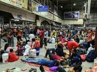 Passengers rest and wait at Howrah train station in Howrah, West Bengal, India, on October 23, 2024. East Coast Railways cancels as many as...