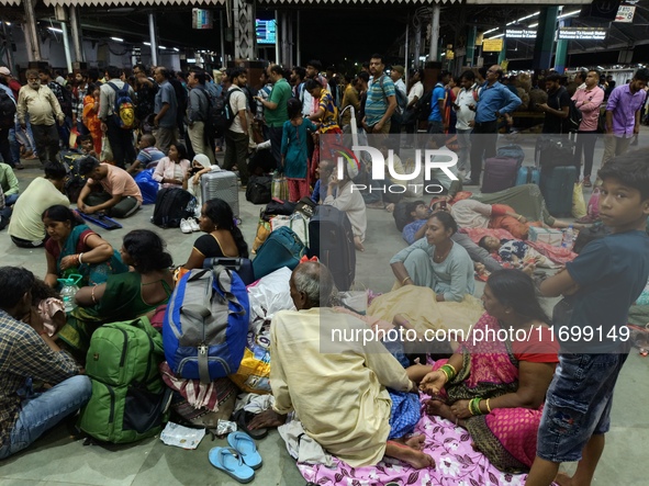 Passengers rest and wait at Howrah train station in Howrah, West Bengal, India, on October 23, 2024. East Coast Railways cancels as many as...