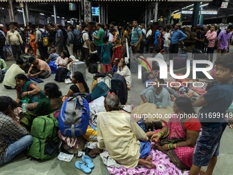 Passengers rest and wait at Howrah train station in Howrah, West Bengal, India, on October 23, 2024. East Coast Railways cancels as many as...