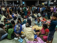 Passengers rest and wait at Howrah train station in Howrah, West Bengal, India, on October 23, 2024. East Coast Railways cancels as many as...