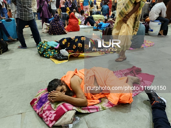 Passengers rest and wait at Howrah train station in Howrah, West Bengal, India, on October 23, 2024. East Coast Railways cancels as many as...