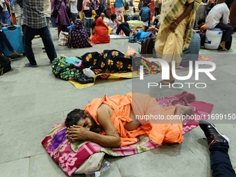 Passengers rest and wait at Howrah train station in Howrah, West Bengal, India, on October 23, 2024. East Coast Railways cancels as many as...