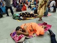 Passengers rest and wait at Howrah train station in Howrah, West Bengal, India, on October 23, 2024. East Coast Railways cancels as many as...