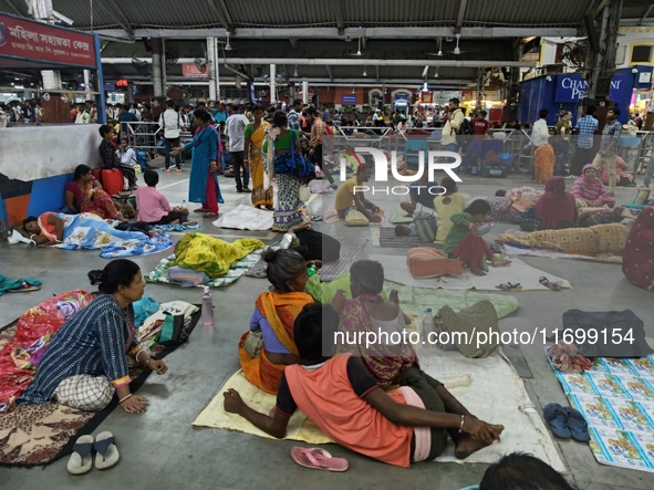 Passengers rest and wait at Howrah train station in Howrah, West Bengal, India, on October 23, 2024. East Coast Railways cancels as many as...