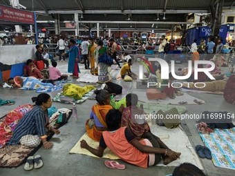 Passengers rest and wait at Howrah train station in Howrah, West Bengal, India, on October 23, 2024. East Coast Railways cancels as many as...