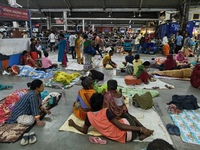 Passengers rest and wait at Howrah train station in Howrah, West Bengal, India, on October 23, 2024. East Coast Railways cancels as many as...