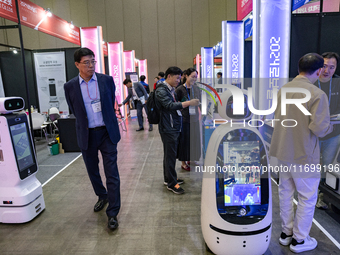 Visitors explore various company booths showcasing robotics and automation technologies at 'RoboWorld 2024' in Goyang, South Korea, on Octob...