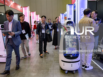 Visitors explore various company booths showcasing robotics and automation technologies at 'RoboWorld 2024' in Goyang, South Korea, on Octob...