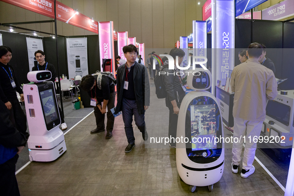 Visitors explore various company booths showcasing robotics and automation technologies at 'RoboWorld 2024,' held at KINTEX in Goyang, South...